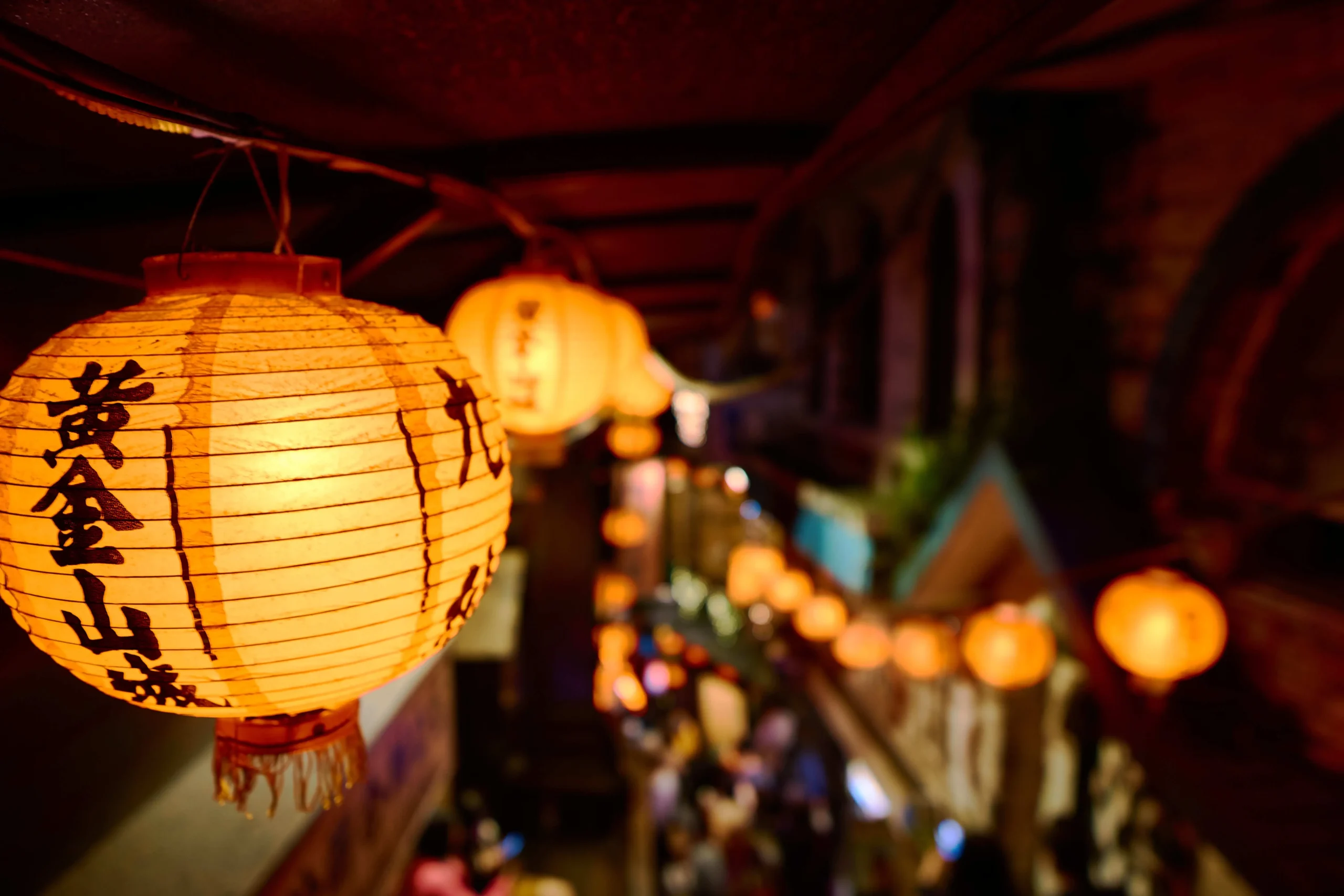 closeup-chinese-paper-lantern-with-lights-surrounded-by-buildings